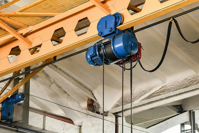An overhead crane in the workshop controlled by electric wires